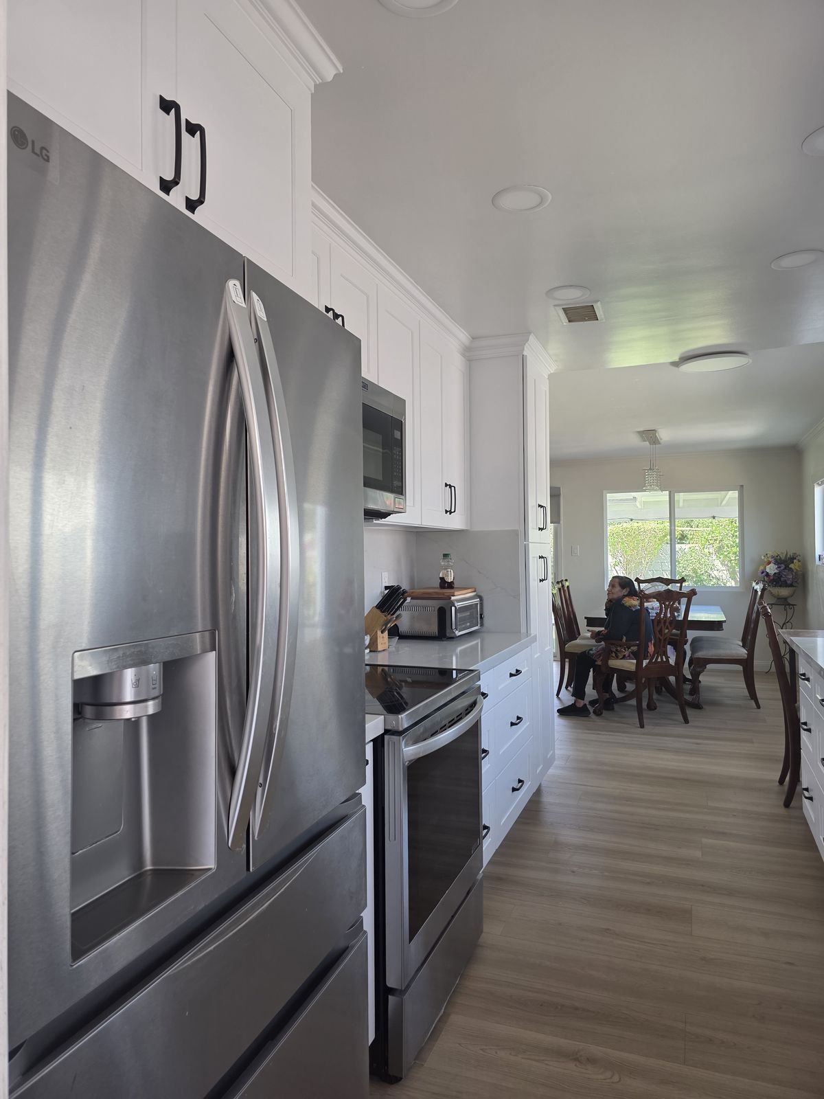 Stainless French-door refrigerator and range, kitchen open to dining room, Buena Park